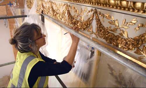 Artisan applying gold-leaf gilding to ornamental detail, EverGreene Architectural Arts