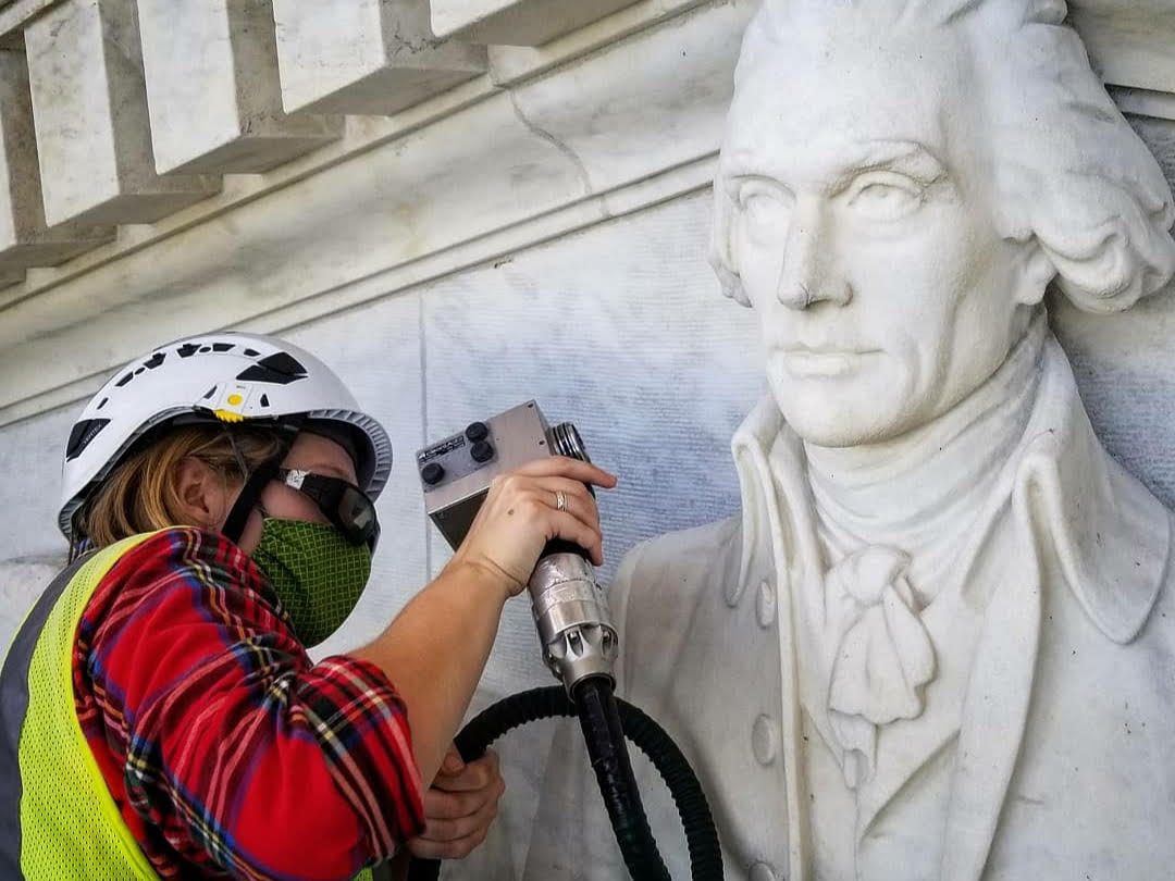 Conservator laser cleaning a sculpted relief at the Jefferson Memorial, Washington DC